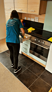 Professional cleaners performing a thorough deep cleaning of a room in London, ensuring every corner is spotless and sanitized